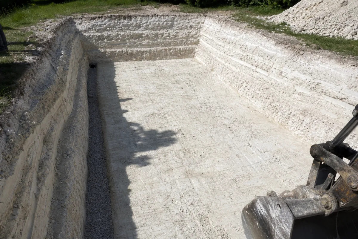 Terrassement d&rsquo;une piscine dans un sous-sol de tuffeau clair, parois de fouille talutées